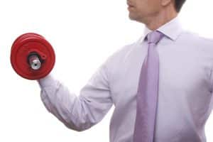 businessman lifting weights (isolated on white)