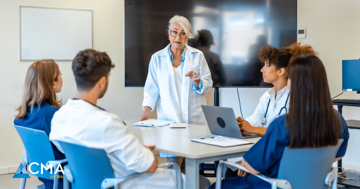 A senior healthcare leader meeting with clinicians to discuss ethics and patient safety.